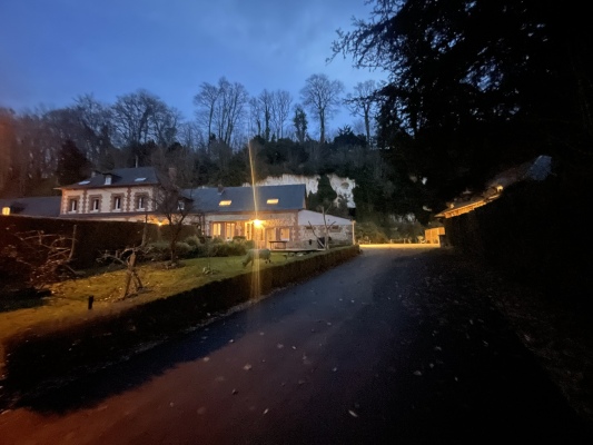 Vue du domaine et de son allée illuminée à la tombée de la nuit